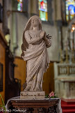 <center> Castellane. </center> L’église du Sacré-Cœur. Statuette en marbre blanc taillé et poli. Femme entièrement drapée ayant les deux mains jointes devant son épaule senestre. Il s'agit probablement d'une représentation de la Vierge. Cette statue proviendrait de la chapelle Notre-Dame-du-Roc et aurait été utilisée pour les processions.