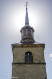 <center>Eglise de la Sainte Trinité des Contamines Montjoie</center>Le clocher est coiffé d’une flèche où se superposent une pyramide basse, un campanile et l’aiguille surmontée d’une boule, d’une croix et d’un coq (la boule la 