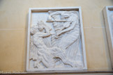 <center>La Musique</center>Bas-relief pour le Théâtre des Champs-Élysées
1912
Plâtre
Don Cléopâtre Sévastos Bourdelle et Rhodia Dufet Bourdelle, 1949<br>
Ce bas-relief obéit aux mêmes principes structurels que celui de La Danse. On y retrouve Vaslav Nijinski en joueur de syrinx (flûte de Pan), tout droit sorti de la chorégraphie de L’Après-Midi d’un faune sur la partition de Claude Debussy (1912). Incarnation de la musique antique, le faune agenouillé dialogue avec une violoniste exaltée qui fléchit sous le cadre. Tant de frénésie disciplinée suscite l’enthousiasme d’Auguste Rodin : «Allez donc voir sur la façade du théâtre des Champs-Élysées ; il y a enfermé dans un carré un faune [...], on attend le moment où il fera sauter le cadre. »