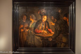 <center>Georges de La Tour Entre ombre et lumière</center>ADAM DE COSTER (vers 1586-1643)
Le Reniement de saint Pierre
Vers 1625 Huile sur toile
Salomon Lilian, Amsterdam/Genève.<br>
Adam de Coster a probablement séjourné en Italie. Il a peint plusieurs Reniement de saint Pierre, sujet prisé des peintres caravagesques pour son potentiel dramatique. Il choisit ici un moment précédant l'arrestation du Christ : une servante s'apprête à dénoncer l'apôtre, éclairé par une bougie dissimulée derrière la main de l'accusatrice, un procédé récurrent chez l'artiste. Au premier plan, des gardes jouent aux cartes autour d'une lanterne, allusion au partage de la tunique du Christ. La disposition des figures et l'intense clair- obscur renforcent l'effet théâtral. De tels tableaux d'Adam de Coster et d'autres caravagesques nordiques circulaient sur le marché parisien, notamment à la foire Saint-Germain ; ils ont pu marquer La Tour, dont les œuvres présentent des affinités évidentes avec leur style.