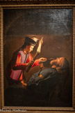 <center>Georges de La Tour Entre ombre et lumière</center>D'APRÈS GEORGES DE LA TOUR (1593-1652)
La Découverte du corps de saint Alexis
Vers 1648 Huile sur toile
Palais des ducs de Lorraine - Musée Lorrain, Nancy
Œuvre prêtée avec l'aimable autorisation de la Société d'histoire de la Lorraine et du Musée Lorrain. <br>
Saint Alexis est une figure légendaire du Ve* siècle, un mendiant qui vécut dix-sept ans sous l'escalier de sa maison familiale sans y être reconnu. Ici, au cœur de la nuit, un jeune serviteur en livrée découvre le corps du saint en soulevant un pan d'étoffe. La torche éclaire son visage surpris, fait briller l'étoffe de ses vêtements et révèle le parchemin que serre Alexis, racontant son histoire. Le saint, vêtu d'une tunique bleu sombre semblable à celle du Saint Pierre repentant de Cleveland, repose dans l'ombre, le visage paisible, comme transfiguré, et sa position possède une dimension christique. Commandé à La Tour en 1648 par la ville de Lunéville pour les étrennes du gouverneur français de Nancy, le tableau original est aujourd'hui perdu.