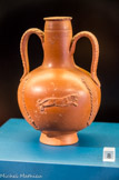 <center>Vase d'EI Aouja</center> Ce vase comporte un décor inspiré des jeux de l'amphithéâtre avec des motifs de lion et de panthère passant entre des palmes. Céramique africaine C. Produit dans un atelier d'EI Aouja (Tunisie). Première moitié du IIIe s.