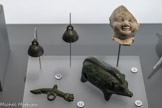9. Fragment de figurine d'enfant souriant appelée risus Ier- IIIe s. ap. J.-C. Terre blanche de l'Allier.
10. Figurine de sanglier. Époque romaine. Bronze.
11. Clochettes Époque romaine Bronze. 12. Amulette en pendentif avec main et phallus IIe - IVe s. ap. J.-C. Bronze.