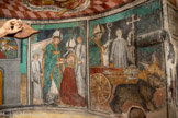 Auron. Chapelle Saint Erige dite d'Ariez <br> Érige reçoit la dernière communion par saint Ysicius, jeune évêque de Grenoble, en présence d’un diacre et d’un enfant de chœur. Funérailles de saint Érige : le corps du saint est porté dans une charrette tirée par un bœuf et un ours – l’ours qui avait tué l’autre bœuf et qui était venu prendre sa place. Ysicius bénit de deux doigts démesurés. Un enfant de chœur tient la croix et un seau d’eau bénite.