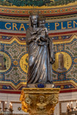 <center>Le maître-autel.</center>La statue de  Jean-Baptiste Chanuel. Le 2 juillet 1837 la statue est bénie par Mgr Fortuné de Mazenod sur le cours Belsunce puis apportée au sommet de la colline de la Garde. Pour lui céder la place, la Vierge au bouquet sera donnée à la chartreuse de Montrieux, mais retournera en 1979 au sanctuaire. Les deux personnages sont couronnés, à la main gauche de l'Enfant est accrochée une ancre. Elle pèse 80kg. Elle a été couronnée en juin 1931, au cours de fêtes très solennelles qui ont duré quatre jours et ont attiré à Marseille des foules énormes. Quarante-neuf évêques étaient présents et le pape avait désigné comme légat pontifical le cardinal Louis Maurin, archevêque de Lyon et ancien recteur de Notre-Dame de la Garde.