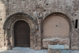 <center>L'abbaye Saint-Victor.</center>Le véritable portail roman de l'église à gauche et, adjacente à lui, la baie d'éclairement des cryptes (deuxième moitié du XIIe siècle). La position du portail,dans la galerie nord du cloître, et non la façade occidentale de l'église, notable par son architecture fermée, montre bien que la fonction monastique s'était dorénavant imposée à l’ensemble du lieu aux dépens du pèlerinage traditionnel qui remontait à l’Antiquité tardive.