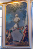 <center>La bibliothèque municipale de Versailles.</center> « L’Europe savante », panneau peint par Jean-Jacques Bachelier, est une allégorie de la suprématie culturelle de la France. Au-dessus de la carte de France se trouve le buste de Louis XV. En arrière-plan trône Le Louvre qui était inoccupé. L'enfant à gauche représente la France avec le coq, celui de droite, l'Europe avec le cheval.