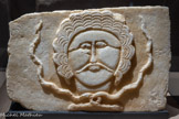 <center>Relief décoré d'un visage d'homme entouré de serpents</center>Zafar (?) 5e s. n. è. Calcaire.
Vienne, Kunsthistorisches Museum Ägyptisch - Orientalische Sammlung, SEM 692 Eduard Glaser, 1894