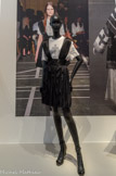 <center>Givenchy par Riccardo Tisci.</center>Robe courte, tee-shirt et cuissardes, collection prêt-à-porter printemps-été 2015, passage n° 32
Robe : polyester, ruban, mousseline ; tee-shirt : coton ; cuissardes : cuir, clou en métal
Givenchy Patrimoine, Paris. 
Certains costumes populaires peuvent témoigner des appartenances religieuses de leurs propriétaires. L'exemple le plus parlant est sans doute la chemise dite « à la croix » du costume de Livno en Bosnie- Herzégovine. Ce désir d'inscrire les croyances individuelles et collectives dans le vêtement se retrouve dans la pratique du créateur contemporain milanais Riccardo Tisri ; la croix est devenue un élément récurrent dans ses créations.