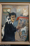 <center>Les Grands Peintres Naïfs.</center> Ferdinand Desnos
1900-1958
Autoportrait aux chats
1953
Huile sur carton