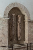 <center>Saint-Philibert de Tournus.</center>Saint-Philibert de Tournus. Le Musée Lapidaire.<br> CLes originaux des statues-colonnes du clocher. Les deux saints tournusiens et les deux cariatides sont du 12e siècle. Philibert est représenté avec le bâton abbatial à gauche et Valérien est sculpté avec la palme du martyre à droite.