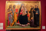 <center>Le musée des Beaux-Arts de Dijon</center>DOMENICO DI MICHELINO Florence (Italie), 1417 - Florence, 1491.
LA VIERGE À L’ENFANT ENTOURÉE DE SAINTS ET D’UN DONATEUR
Vers 1460. Bois.
L’influence de Fra Angelico, dont Domenico di Michelino a été l’élève, mêlée à des souvenirs de Lippi et de Pesellino, est encore sensible dans cette représentation, cependant tardive avec une raideur un peu sèche.