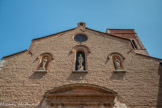 <center>Notre-Dame de la Réal.</center>Le clocher carré du 14e siècle subsiste en grande partie. Il a été découronné et fortement endommagé en 1539 par le canon de la garnison castillane du château royal. Du clocher gothique originel il ne reste donc que la base.  Statues de St Joseph de la Vierge et de St Simon Stock.