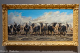<center>Les Menons en tête d’un troupeau en Camargue</center>Émile Loubon
Aix-en-Provence, 1809 – Marseille, 1863.
Huile sur toile.
Présentée à Paris au Salon de 1853 avec Vue de Marseille prise des Aygalades, la peinture attire les réactions de la critique stupéfaite et ironique devant l'œuvre de Loubon. Elle fera même l’objet d'un dessin satirique par Nadar dans son album comique du Salon. La représentation du mouvement des troupeaux sur les routes poudreuses de Provence, la réduction des tons et de la couleur, la vue panoramique, sont autant d’obsessions récurrentes chez Loubon qui acquièrent ici, par les dimensions du tableau, une présence surprenante d’autant que la figure humaine disparait dans la poussière au second plan. Les boucs noirs sont des menons (du provençal « menar », mener). Il s'agit de boucs castrés qui dans les collines du Rove étaient