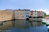 <center>Port Grimaud.</center>Les travaux de la première tranche débutèrent en juin 1966 et se poursuivit jusqu'au printemps 1968. Aux premiers logements livrés venait s'ajouter 130 appartements et studios donnant sur la plage, ainsi que trente locaux commerciaux sous arcades et sur la « place des Six-Canons ». Afin de faciliter l'intégration des nouvelles constructions dans le paysage méditerranéen et les faire paraître aussi authentiques que n'importe quel village provençal, Spoerry n'hésita pas à réutiliser les matériaux (carrelages, tuiles, éléments de charpente, menuiserie, ferronnerie…) issus d'un chantier de démolition d'un quartier de Romans-sur-Isère. Depuis 2001, Port Grimaud est labellisé « Patrimoine du XXe siècle ».