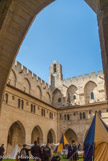 Palais des papes d'Avignon. La cour du cloître. A gauche, l'aile des Hôtes ou aile du Conclave s'étage sur trois niveaux. Au rez-de-chaussée se trouve le Grand Cellier ; au-dessus, les appartements des bouteillers et des panetiers, et le troisième étage (30 mètres de long et de plain-pied), appelé « chambre de l'Empereur » depuis que Charles IV de Luxembourg y séjourna